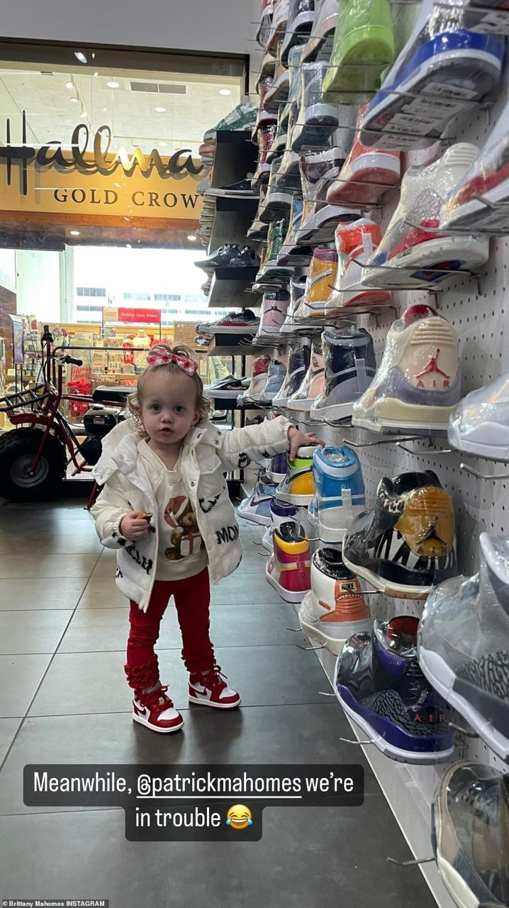 Trouble: She also shared another snap of Sterling checking out a wall of sneakers at a store, adding in the caption, 'Meanwhile, @patrickmahomes we're in trouble'
