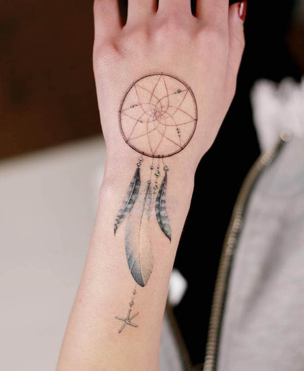 Dreamcatcher hand tattoo by @tattooist_doy