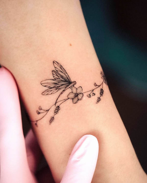 Girly dragonfly bracelet tattoo by @bunami.ink