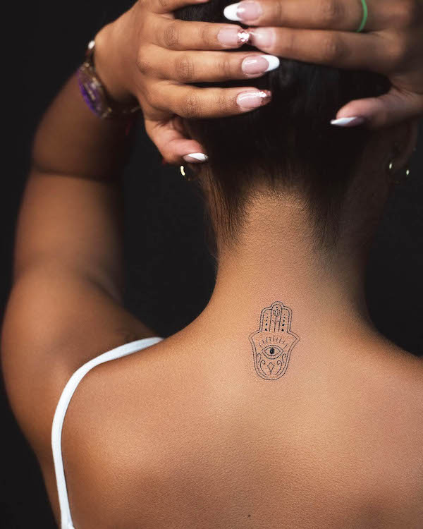 Hamsa tattoo on the back of neck by @alegomeztattoo