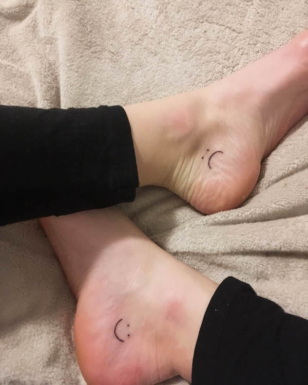 Smiley and crying face ankle tattoos by @handost