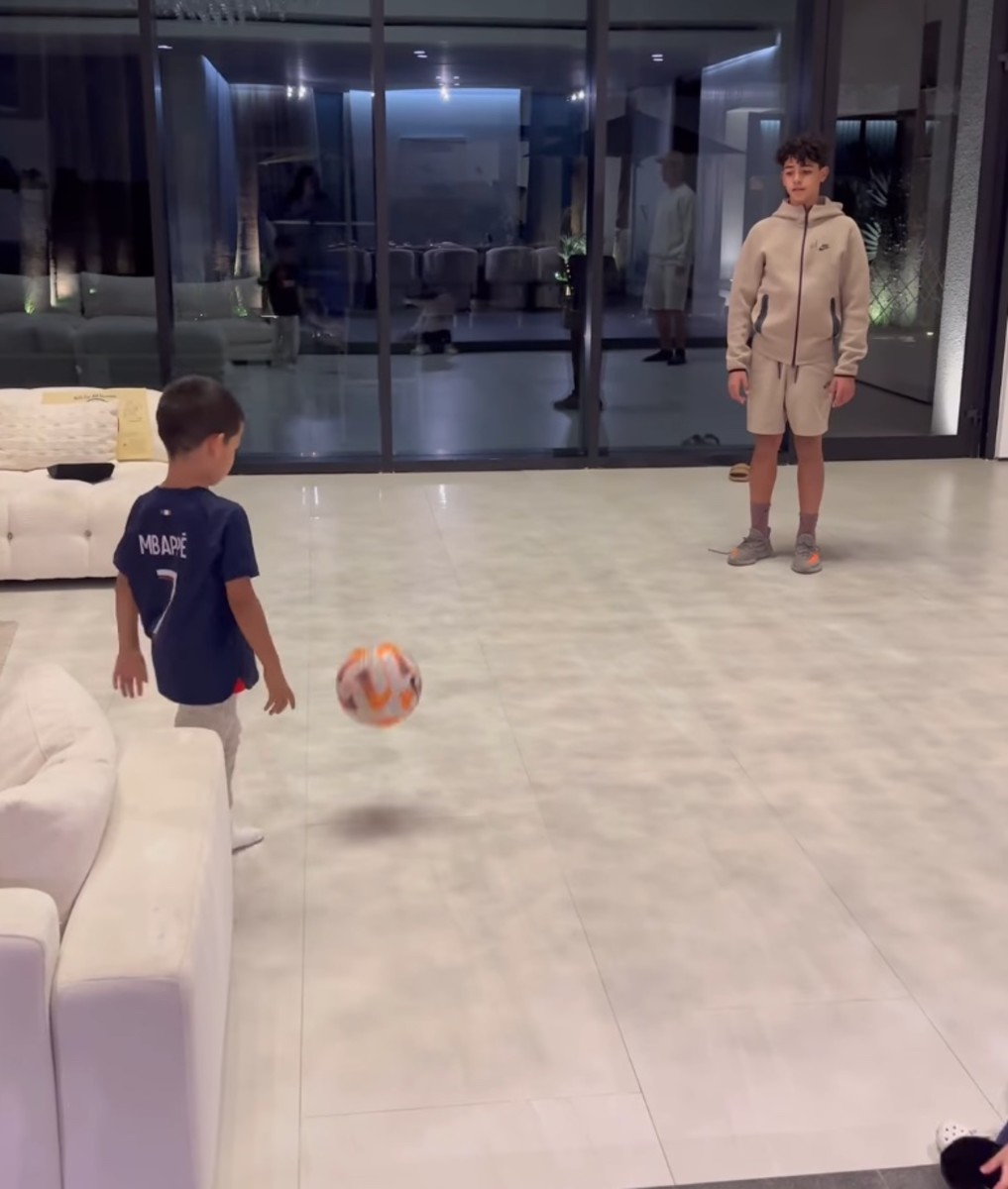 Cristiano Ronaldo's sons Mateo (left) and Cristiano Jr pictured playing football at home in Saudi Arabia in December 2023