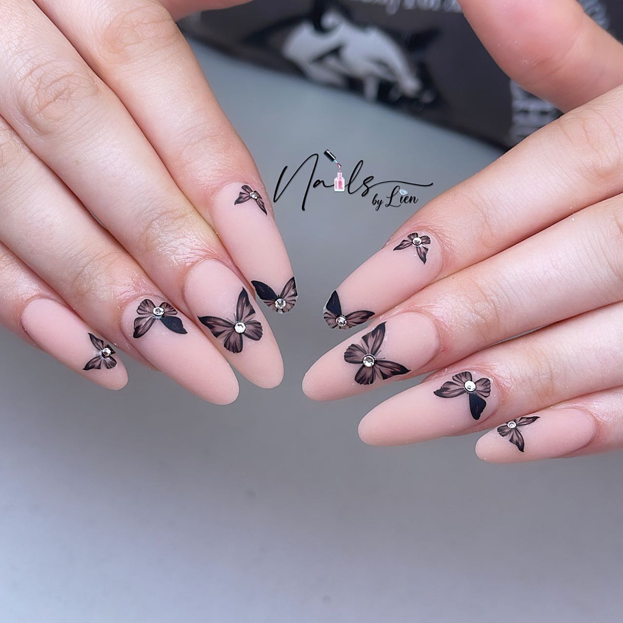 Matte nails are one the coolest things and it is an easy way to get a perfect vibe. With nude matte nails and black butterflies, you will rock!