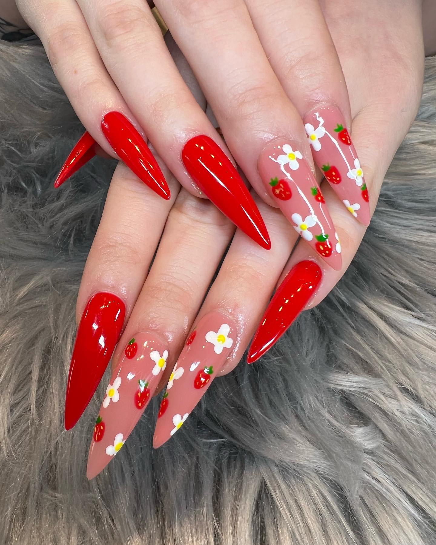 Red nails are super sexy but to make it look cute, you can use accent nails with a combination of small strawberries and daisies.