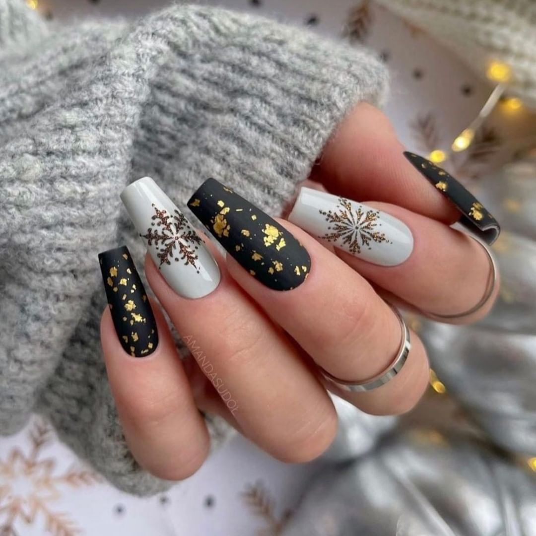 Black matte and grey shiny nails look perfect with their gold glitters and snowflakes with tiny stones. Go for it if you want to achieve a chic look.