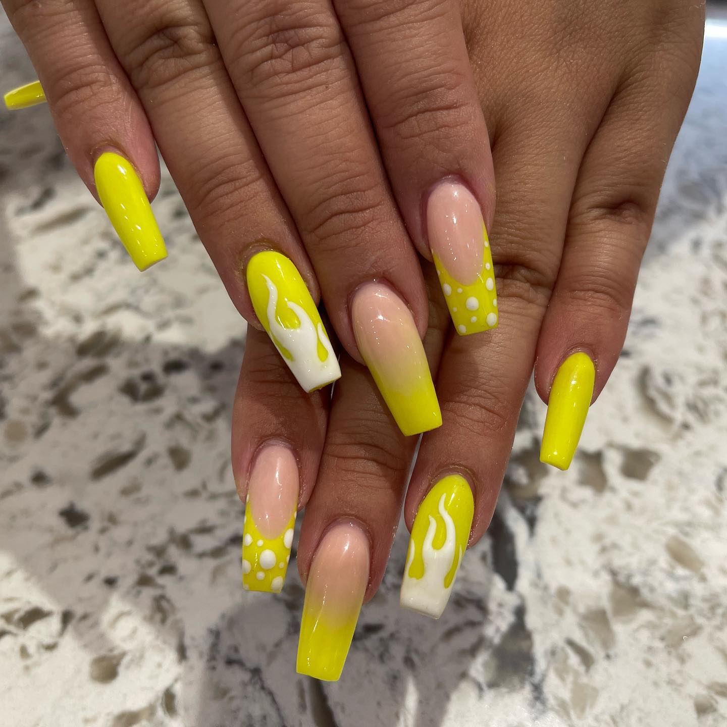 Yellow and long nails will look popping for the summer! Go for these long acrylics and show them off at most party events.