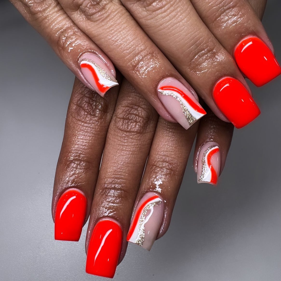 Red nail polish is already a super cool thing but if you want more, you should definitely go for these accent nails. Swirl glittered nails are perfect.