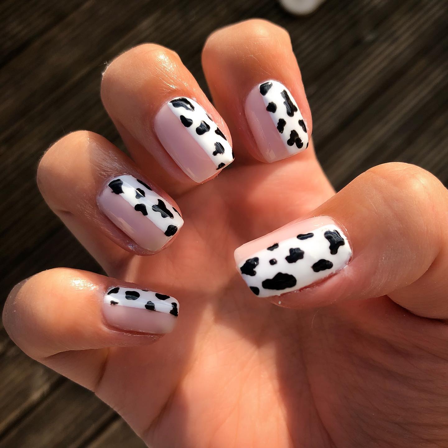 If you are into nude nail polishes but wanna try something new, you should go for half nude half cow print nails like the ones above. First, you need to apply nude nail polish to half of your nail and white one to the other. Then, draw random dots to create the nail art.