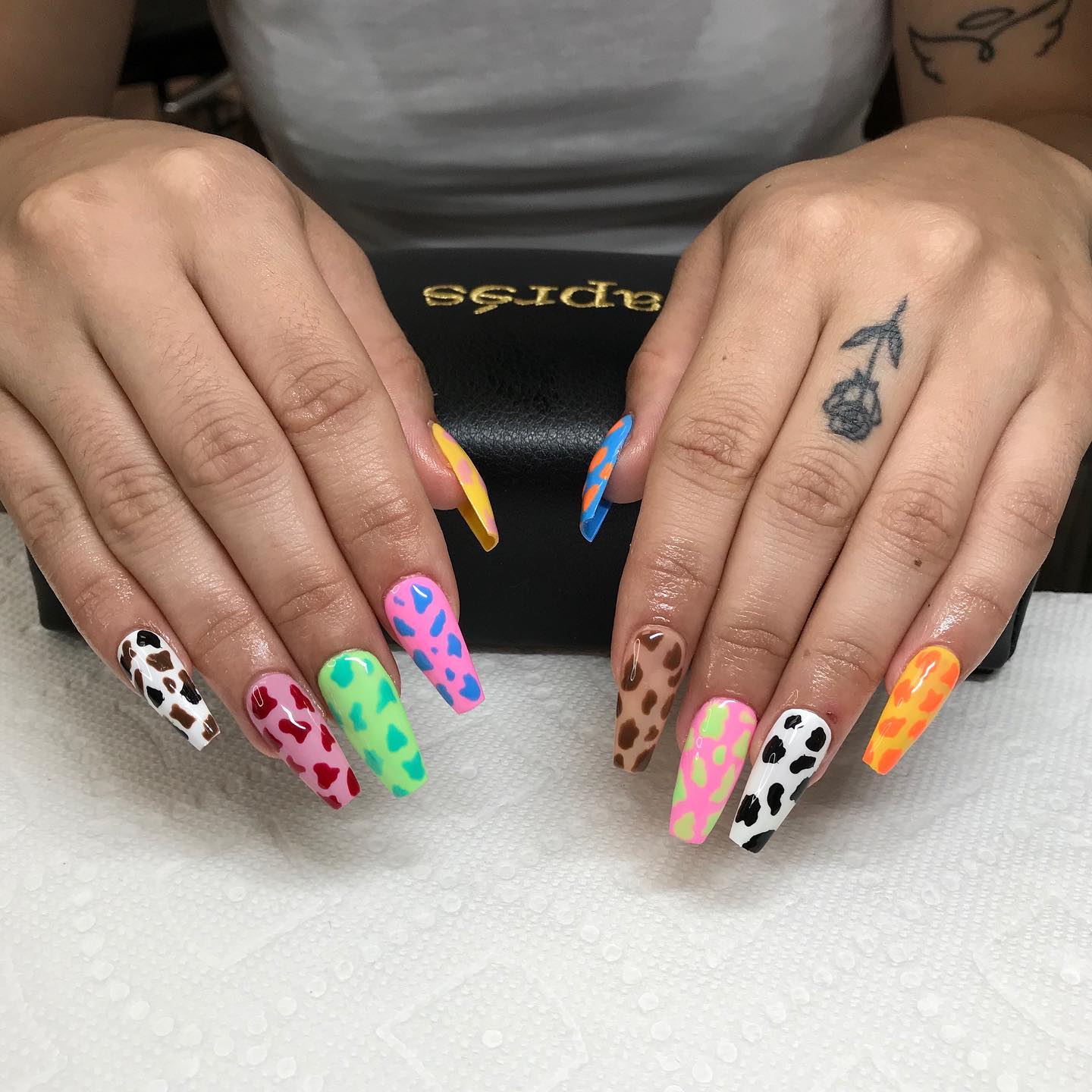 Black and white cow print nails are nice but why not having fun with them? If you want to do so, you can apply different colored cow prints for your each nail and rock.