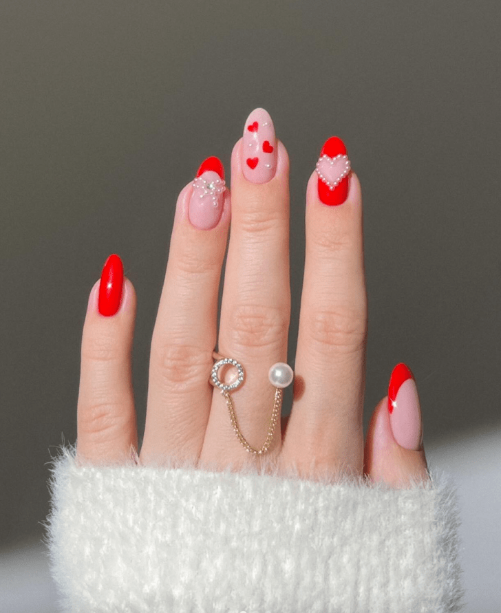 cute red Valentines Day nails with pearl decals and heart and bow nail art
