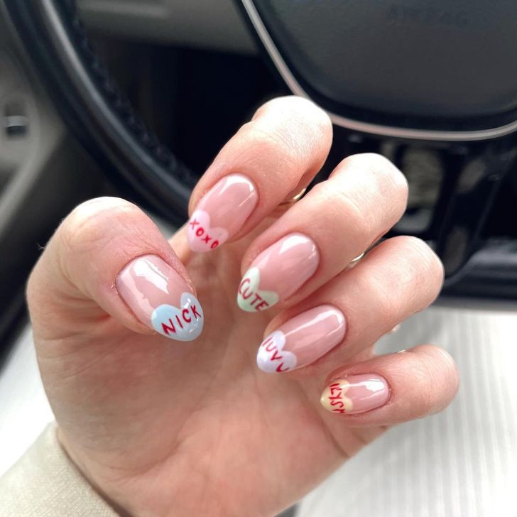 cute short Valentines Day nails with colorful candy heart designs on the tips