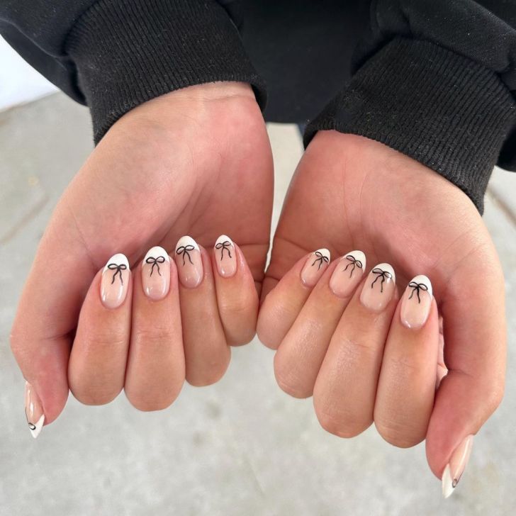 cute white french tip Valentines nail designs with black bow nail art