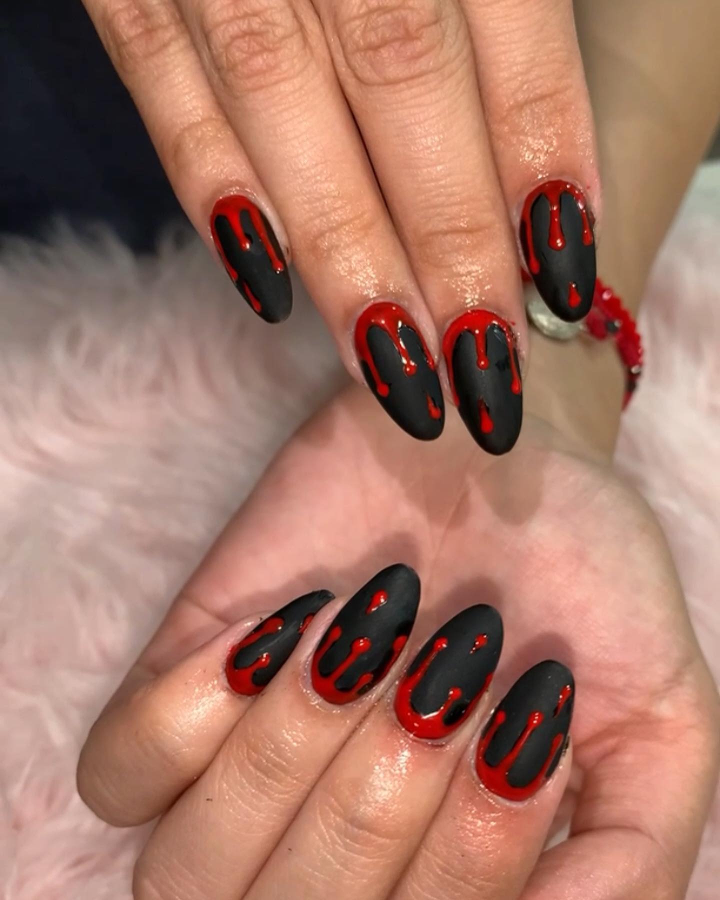 Wanna have bloody nails? Black matte nail polish is combined with a blood red nail polish and it is quite sexy, isn't it? Blood drops are placed at the top of the nail and they fall into the tips. It can be a great Halloween nail idea, too.