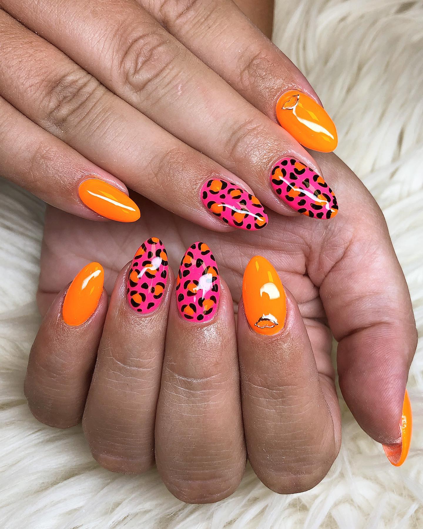 To show your inner strength on your nails, a leopard print will be a nice choice. Also, orange and pink color go well together.