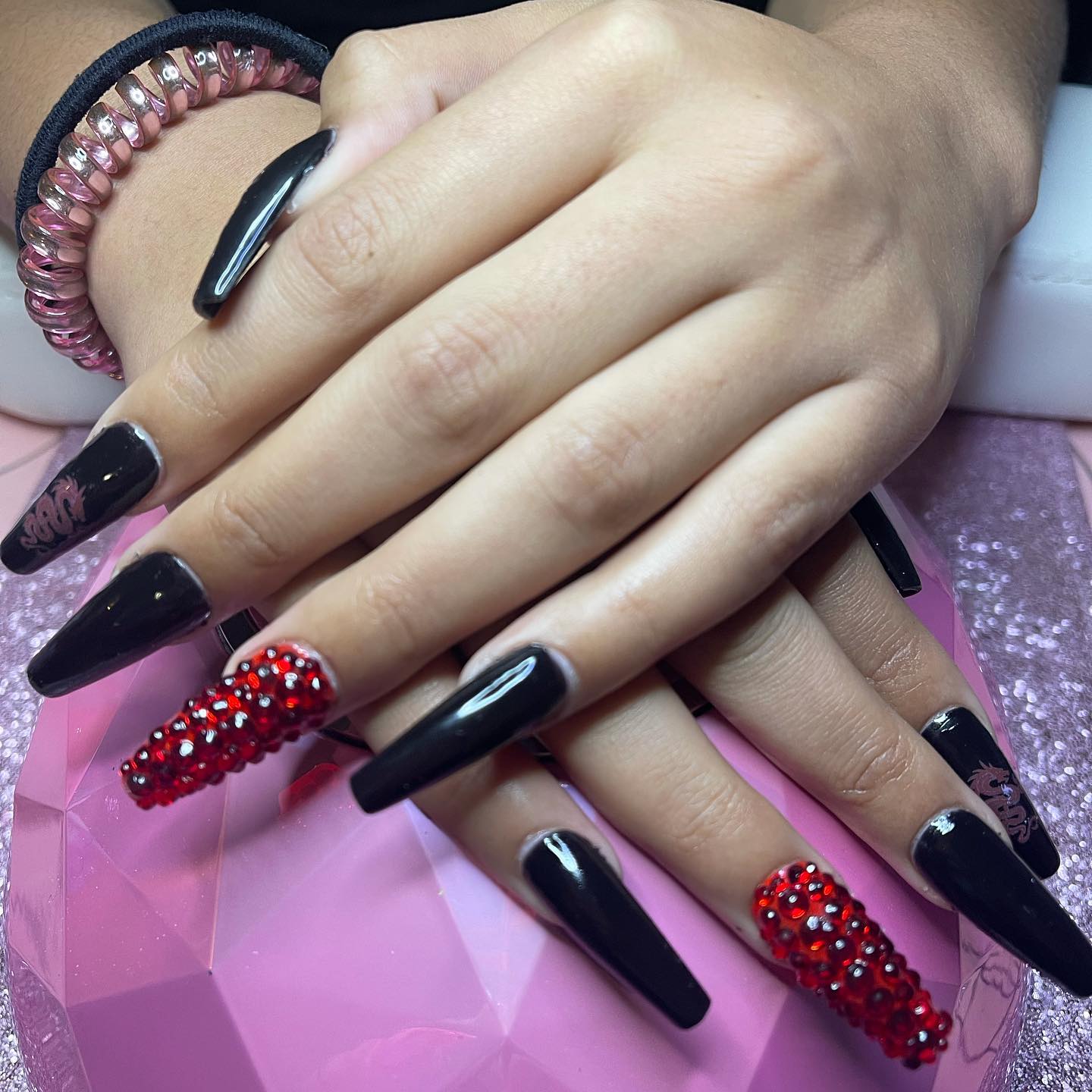 Black long coffin nails offer an amazing look for the ones who apply it. Are you ready to have fun with your long nails? Then, red accent nails with some shiny stones on them are all you need.