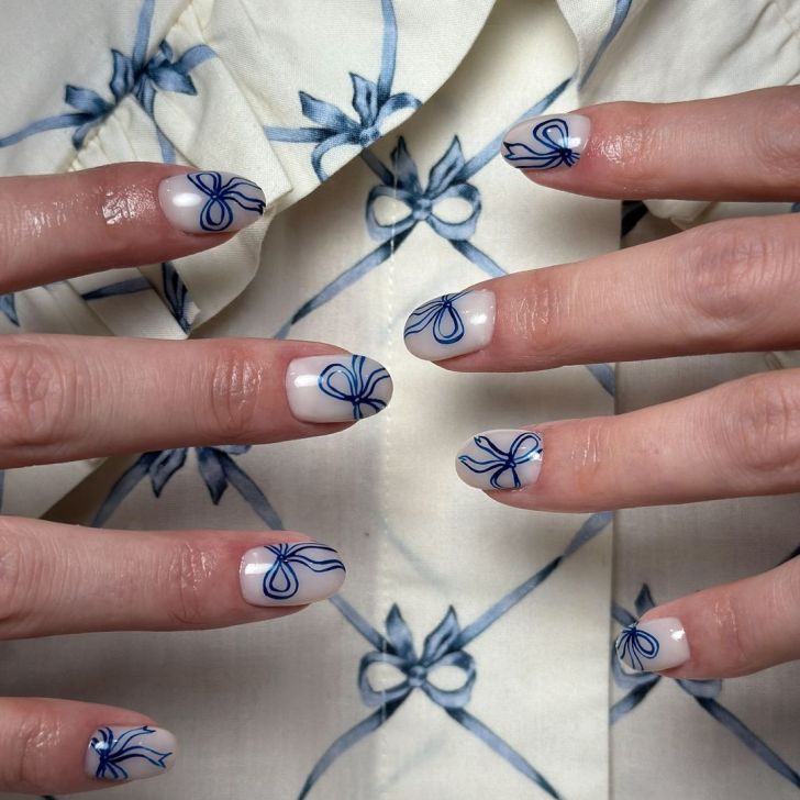 short and simple milky white Valentines Day nails with cute blue bow outline designs