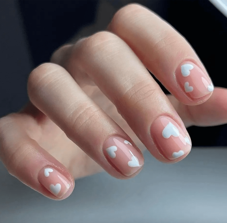 simple short Valentines Day nails with cute white heart designs