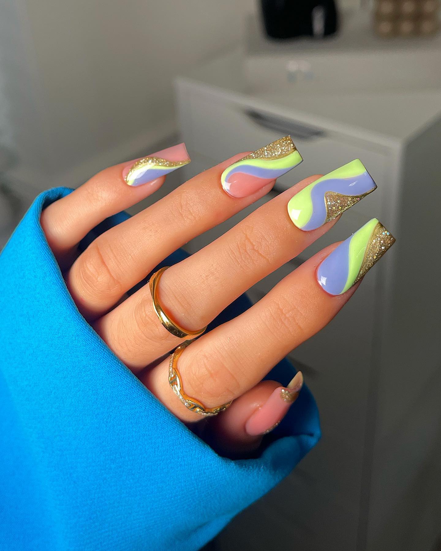 These nails are absolutely adorable! Big green and blue pastel swirls are amazing to combine with glittered ones.