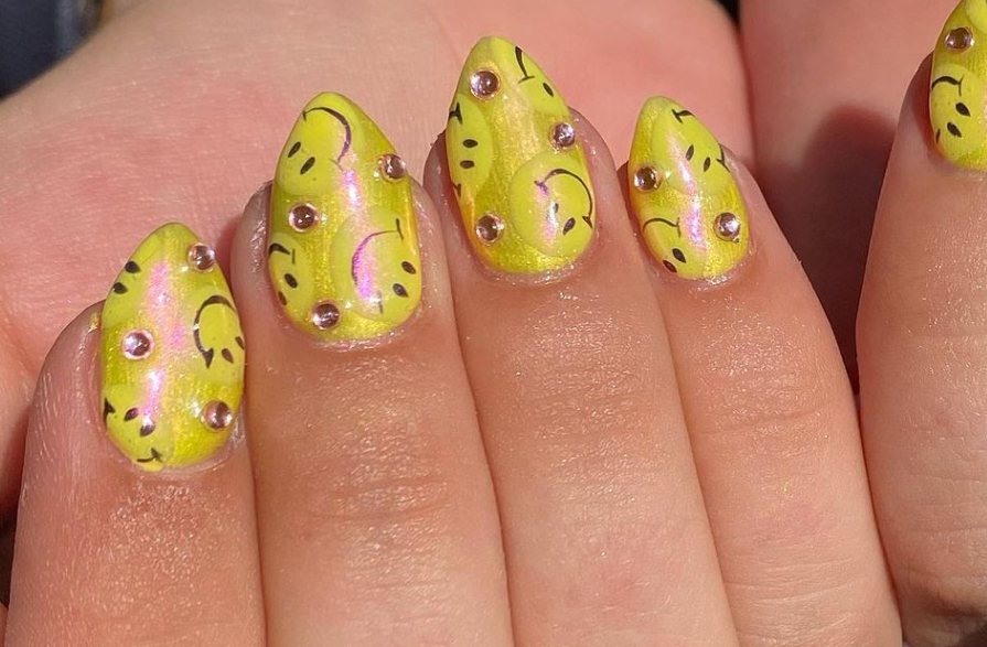 yellow nails with smiley face nail design