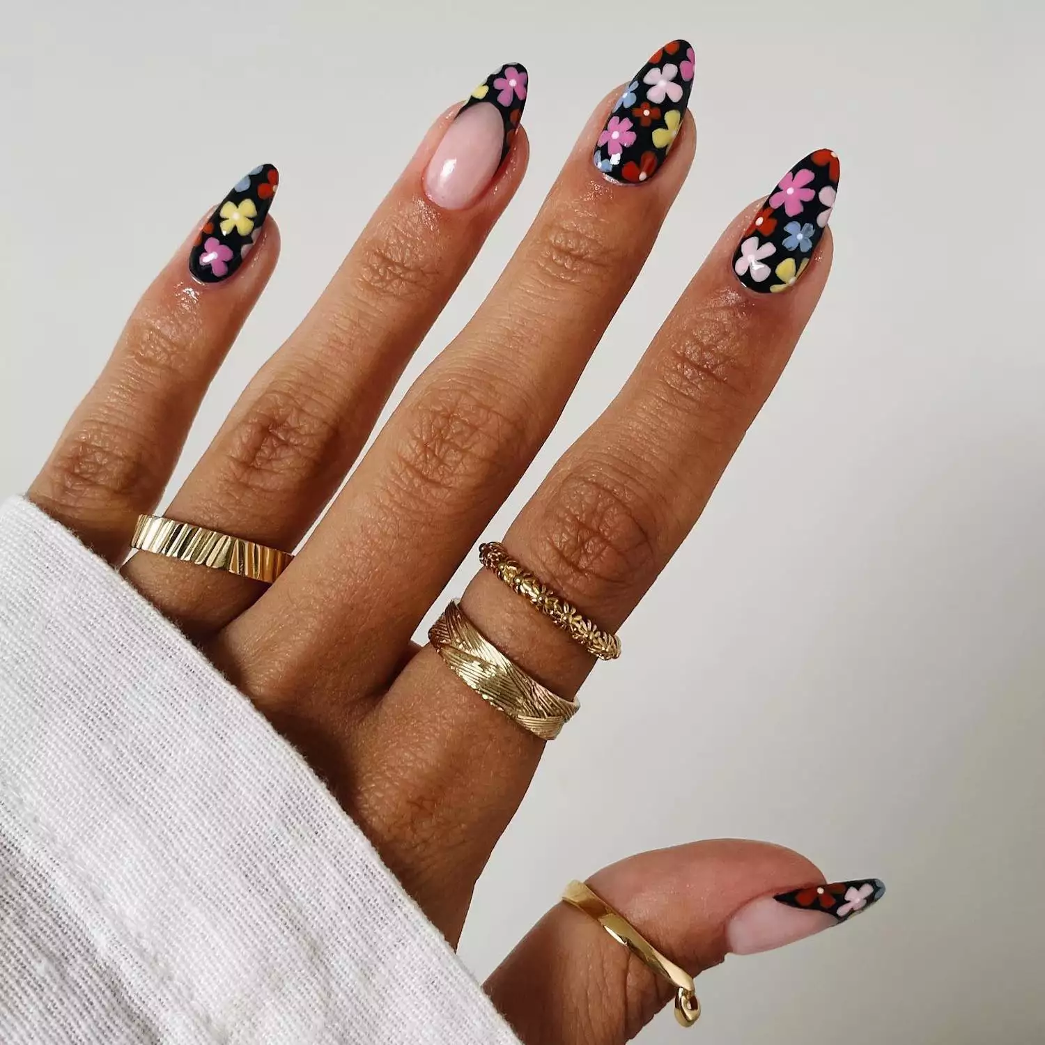 Black manicure with multicolored dark retro florals and French tip accent nails