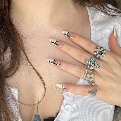 Tattoo-inspired angel number nail art is on-trend for 2024's Aquarius season.