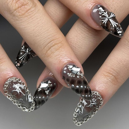 Edgy silver nail jewelry is on-trend for 2024's Aquarius season.