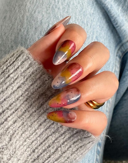 Whimsical watercolor-inspired nail designs are on-trend for 2024's Aquarius season.