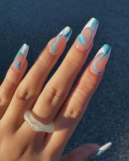 French tip nails with aqua blue swirls are on-trend for 2024's Aquarius season.