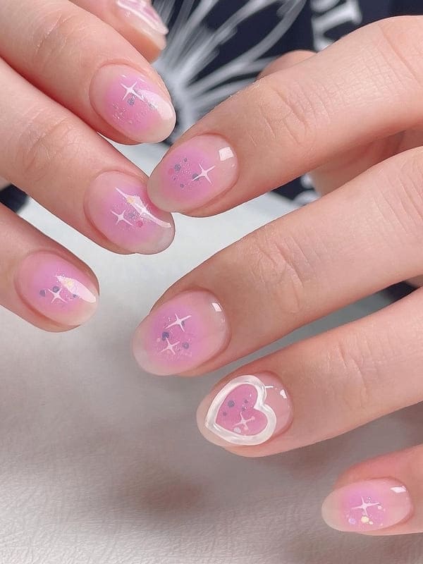 pink blush nails with 3D heart accents