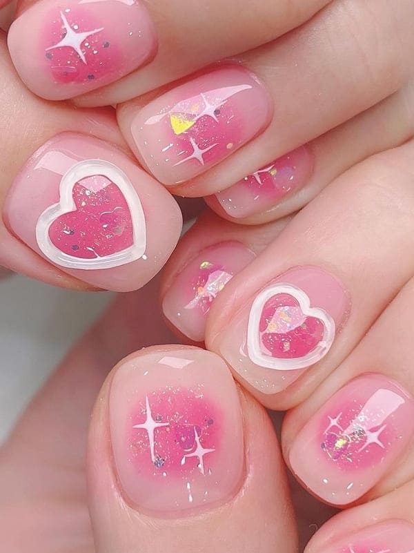 pink blush nails with 3D heart accents