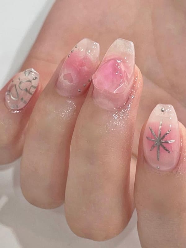 pink blush nails with 3D heart accents