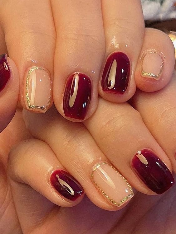 Korean burgundy and gold nails: geometric lines