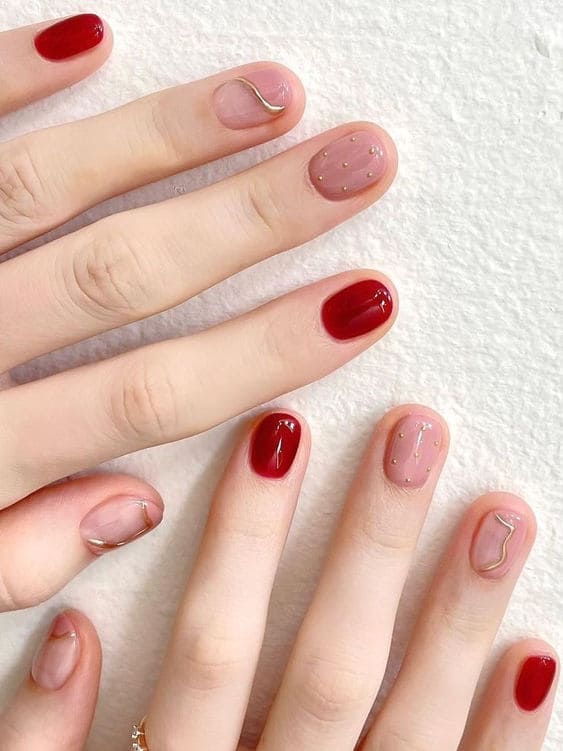 Korean burgundy and gold nails: geometric lines