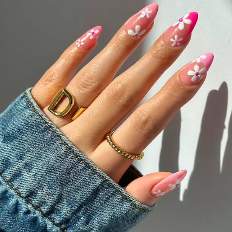 Pink french tip nails with '70s inspired flower design