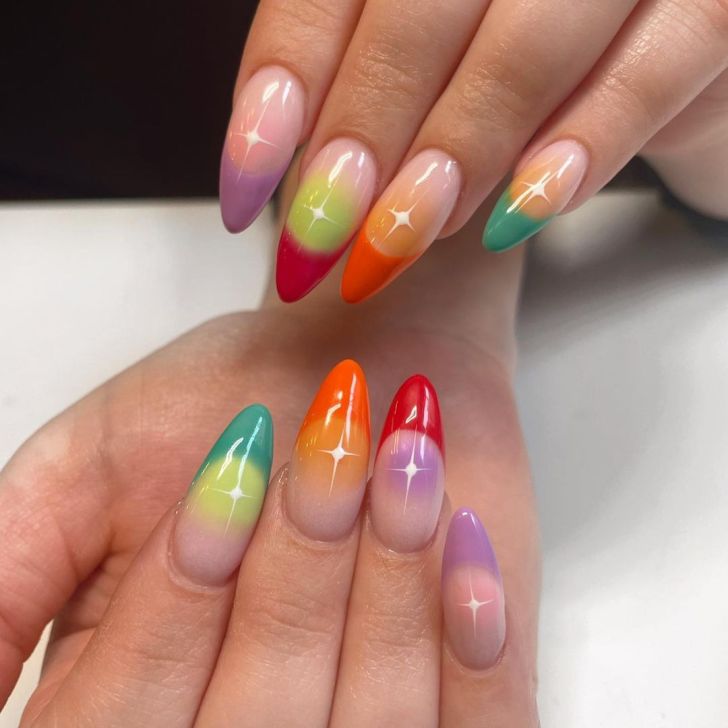 colorful rainbow French tip aura nails with a white celestial star accent design