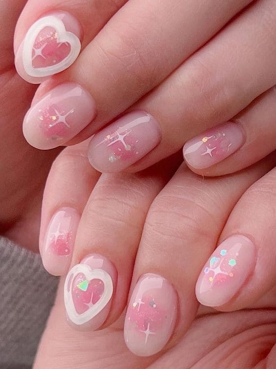 glittery pink blush nails with heart rings