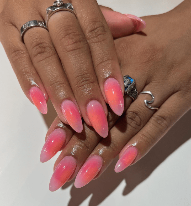 pink and orange sunset inspired aura nails with white celestial nail art star accents