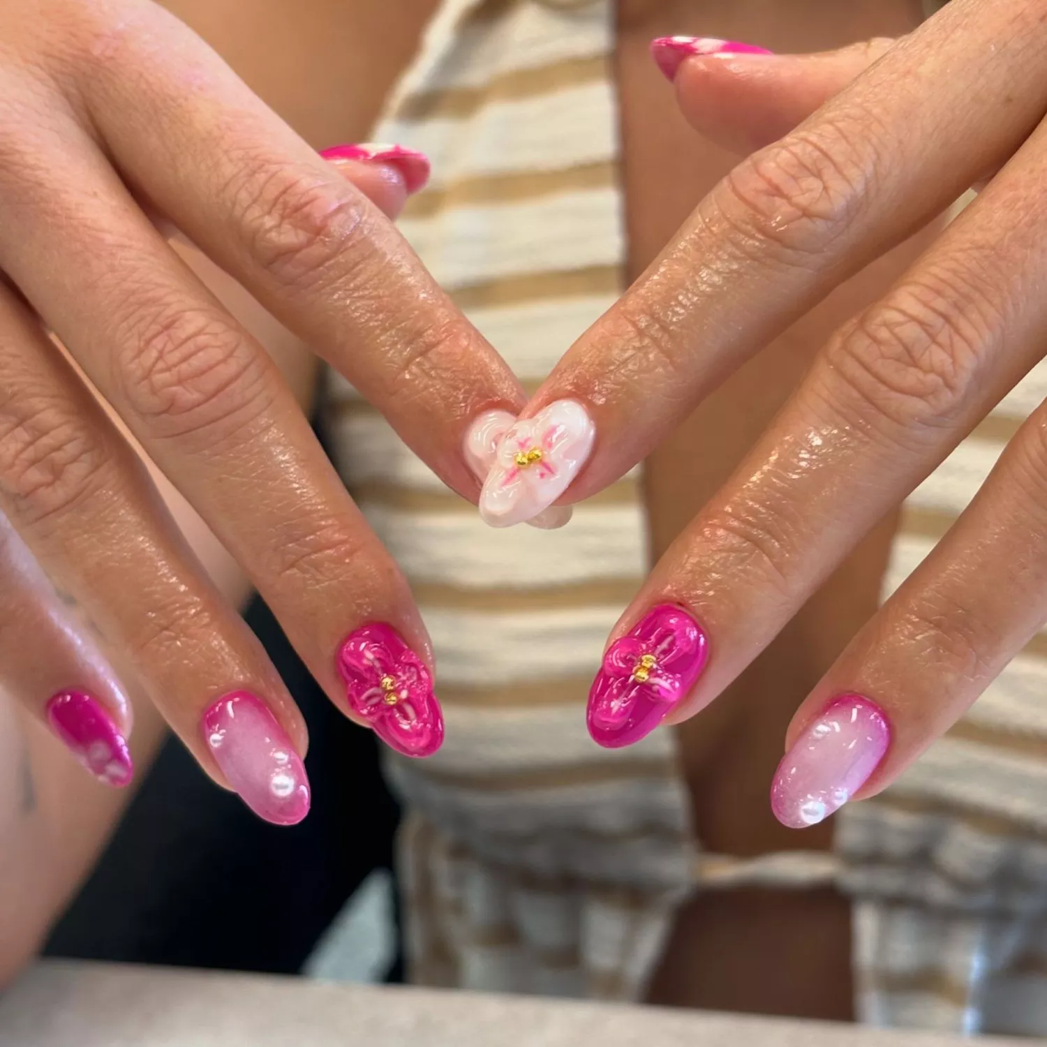 Hot pink and baby pink nails with gel hibiscus nail design and pearl gems