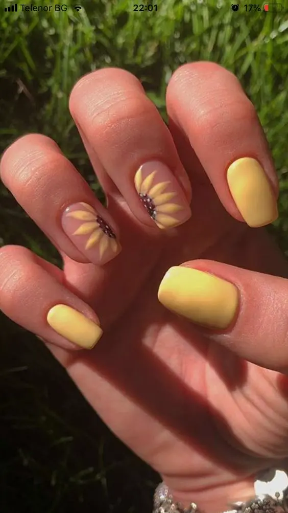 Soft matte yellow square nails with two accent nails showcasing hand-painted sunflowers. This cheerful design embodies the warmth and vibrance of summer, ideal for sunny days.Soft matte yellow square nails with two accent nails showcasing hand-painted sunflowers. This cheerful design embodies the warmth and vibrance of summer, ideal for sunny days.