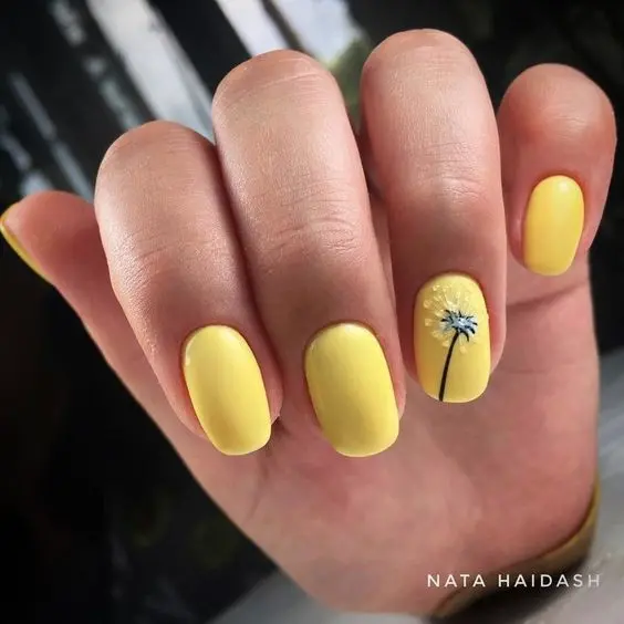 This design features squoval-shaped nails painted in a bright, summery yellow. The accent nail showcases a delicate dandelion design, symbolizing wishes and new beginnings. Perfect for a cheerful and optimistic summer look.