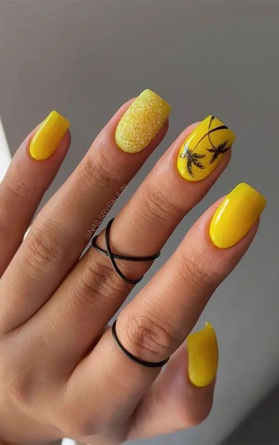 These square nails feature a bright yellow base, with one accent nail showcasing black palm tree silhouettes. Perfect for a tropical summer vibe, they radiate warmth and vacation feels.