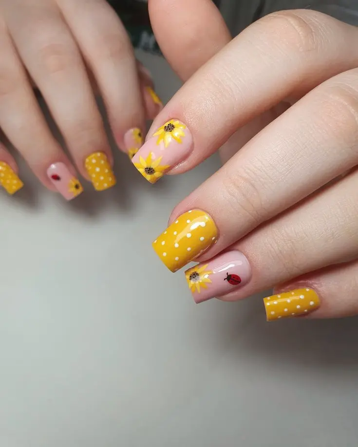 Square nails in bright yellow with white polka dots and sunflowers on accent nails. This fun and lively design is perfect for showcasing your cheerful summer spirit.