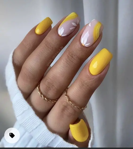 Square nails painted in a vibrant yellow with accent nails featuring white daisies and a yellow wave design. This playful and refreshing style is ideal for sunny summer days.