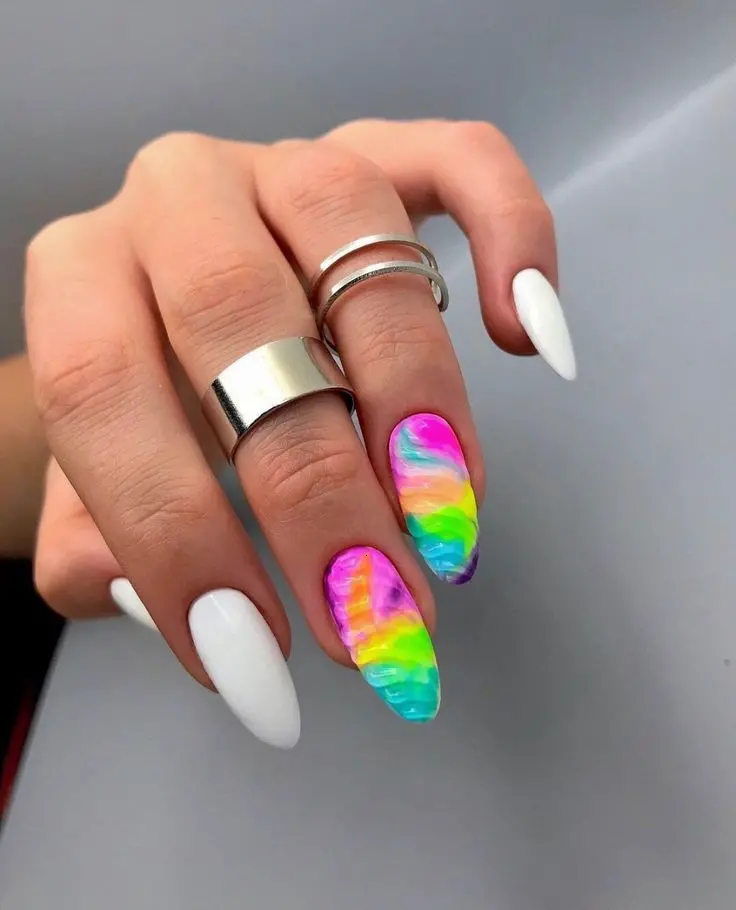 Bold and striking, these long almond nails mix a classic white base with a vibrant neon rainbow tip. The vivid colors flow smoothly across each nail, creating a dynamic and eye-catching effect suitable for fashion-forward individuals.