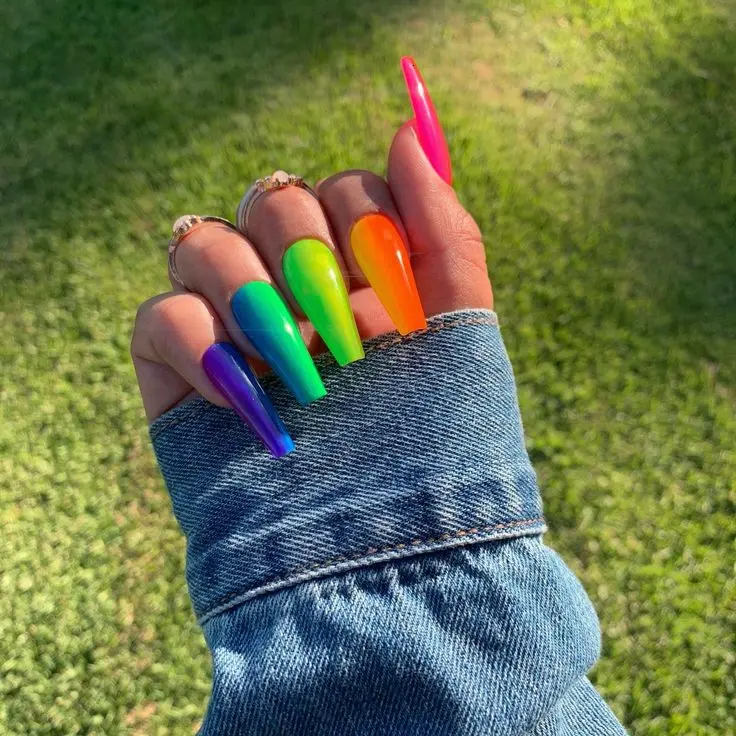 Bold and vibrant, these ballerina nails showcase a glossy finish with a rainbow gradient. Each nail fades into the next, creating a seamless spectrum of neon colors that capture the lively spirit of the rainbow, ideal for summer and festive occasions.