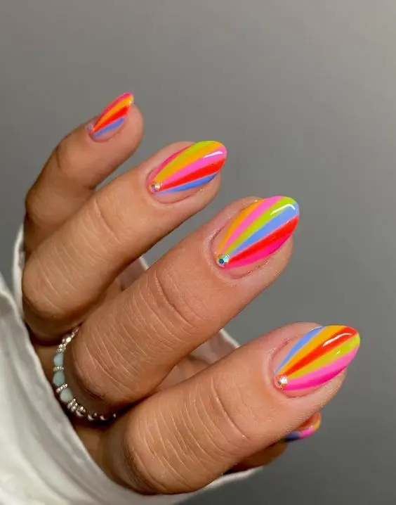 Vibrant neon rainbow stripes on a glossy almond nail design. Each stripe is distinct and neatly applied, offering a colorful spectacle that is both eye-catching and stylish.