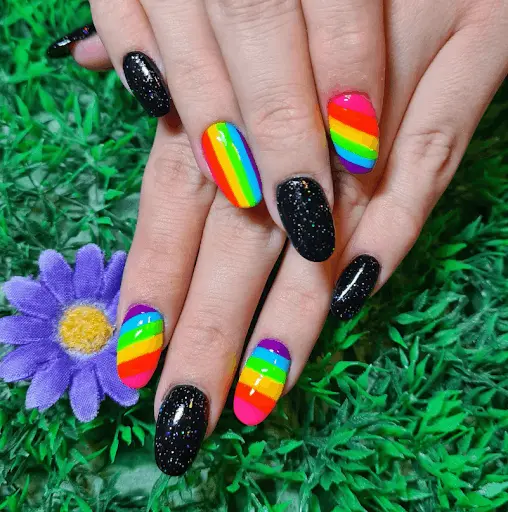 This chic design blends traditional black nail polish with bright neon rainbow stripes, creating a stark yet vibrant contrast. The combination is perfect for those looking to balance classic elegance with a touch of playful brightness.