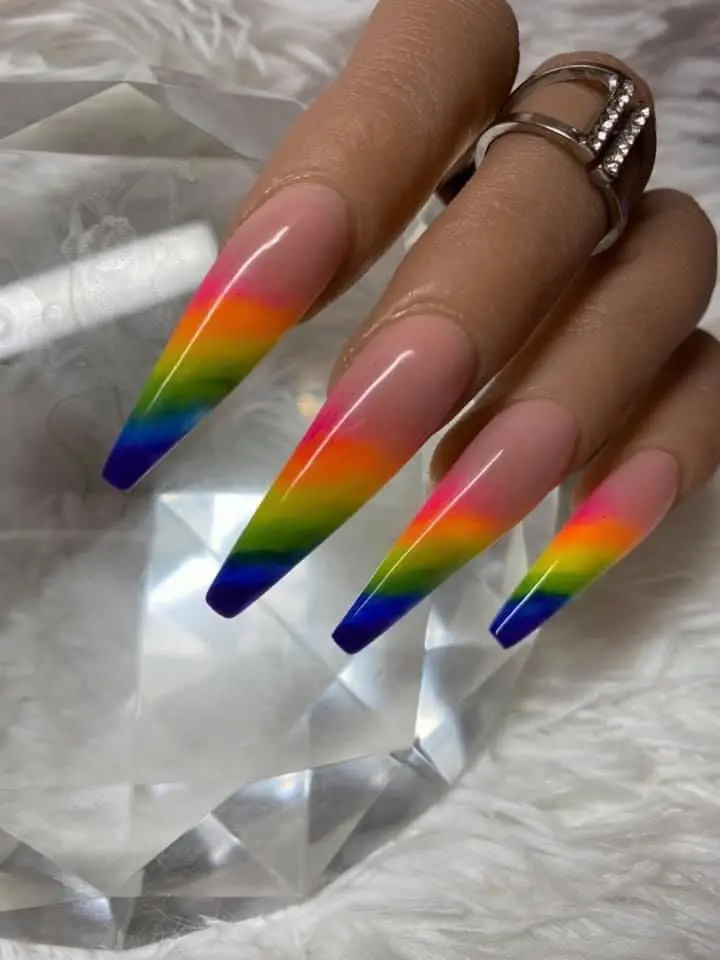 These ballerina-shaped nails boast a crystal clear tip with a striking neon rainbow gradient. The design transitions smoothly through each hue, resembling the natural beauty of a rainbow in a stylish and sophisticated manner.