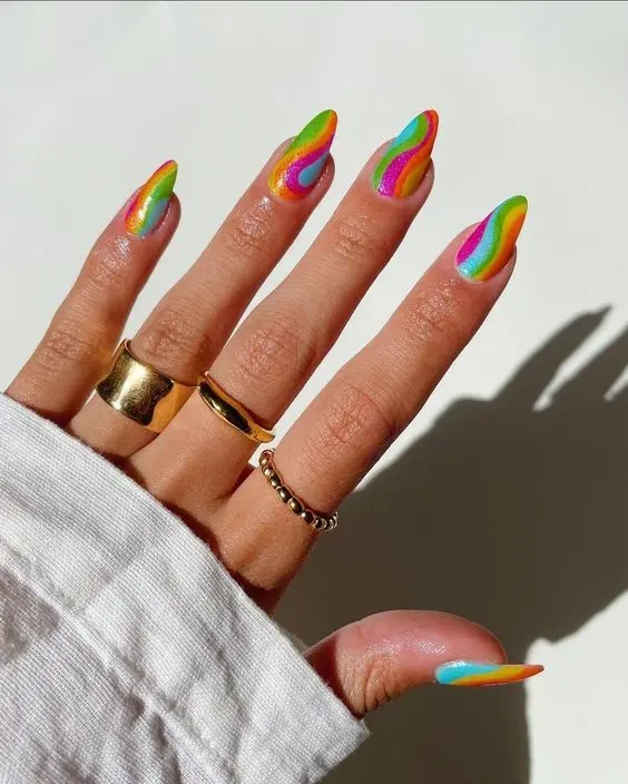 Elegant almond-shaped nails featuring a diagonal neon rainbow design. The nails display a smooth transition of colors including red, orange, yellow, green, blue, and purple, perfect for adding a splash of color to any outfit.