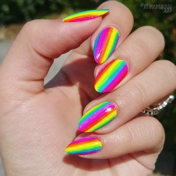 Bright and bold, these almond-shaped nails are painted with horizontal neon rainbow stripes. The vivid colors of red, orange, yellow, green, blue, and purple make these nails stand out, ideal for sunny days and outdoor festivals.